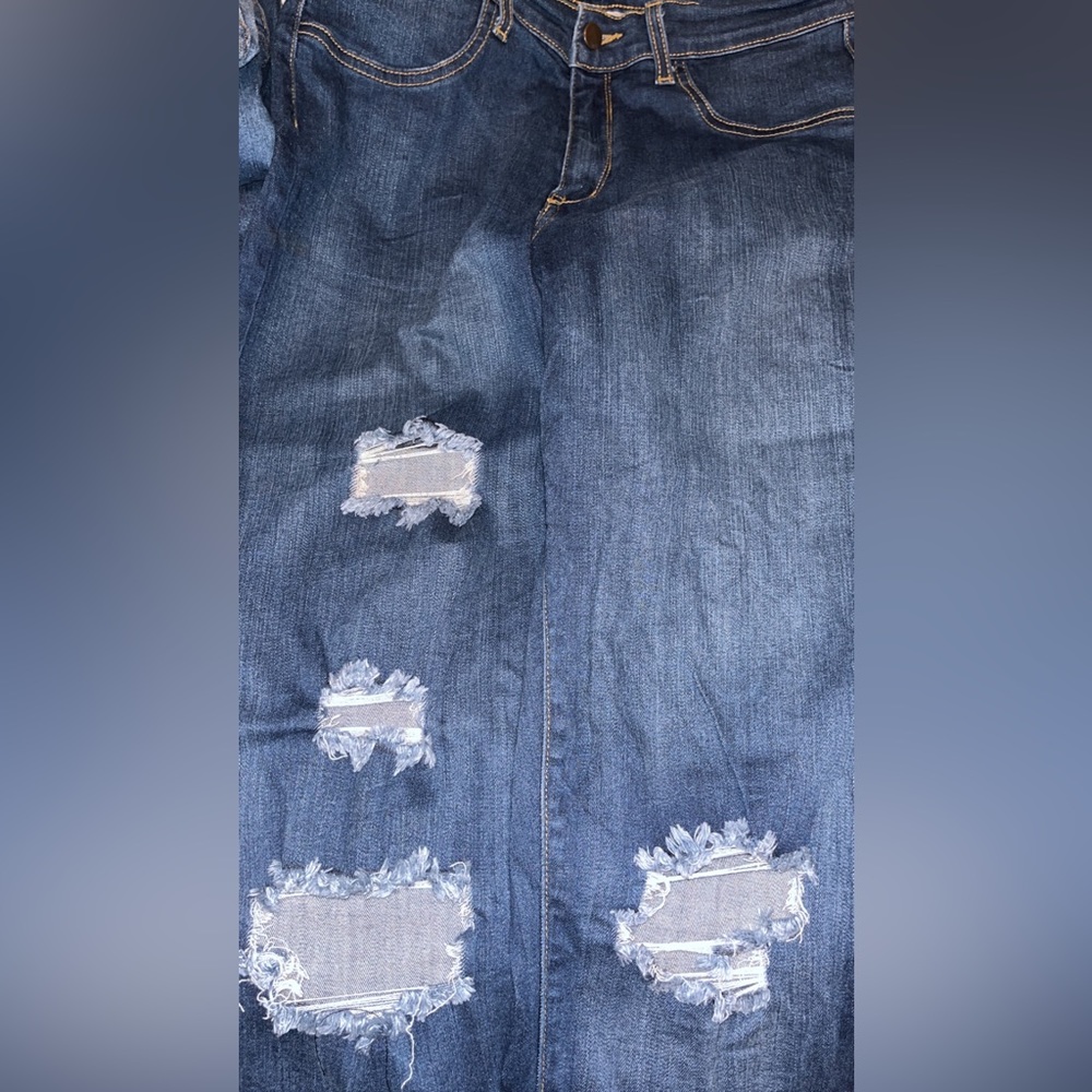 Darker washed distressed denim